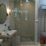 custom shower door white tile bathroom and mirror