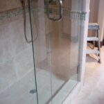 custom bathroom floor and glass shower door installation