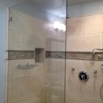 customized shower in bathroom with glass shower doors