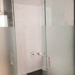 bathroom with open glass shower doors