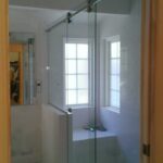 bright bathroom with custom frameless glass shower door 2017