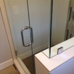 new glass doors and door handle in custom bathroom southern california